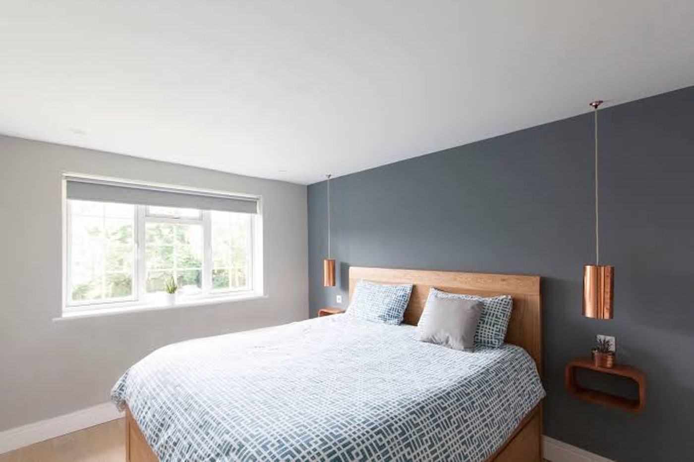 Freshly decorated bedroom with grey feature wall