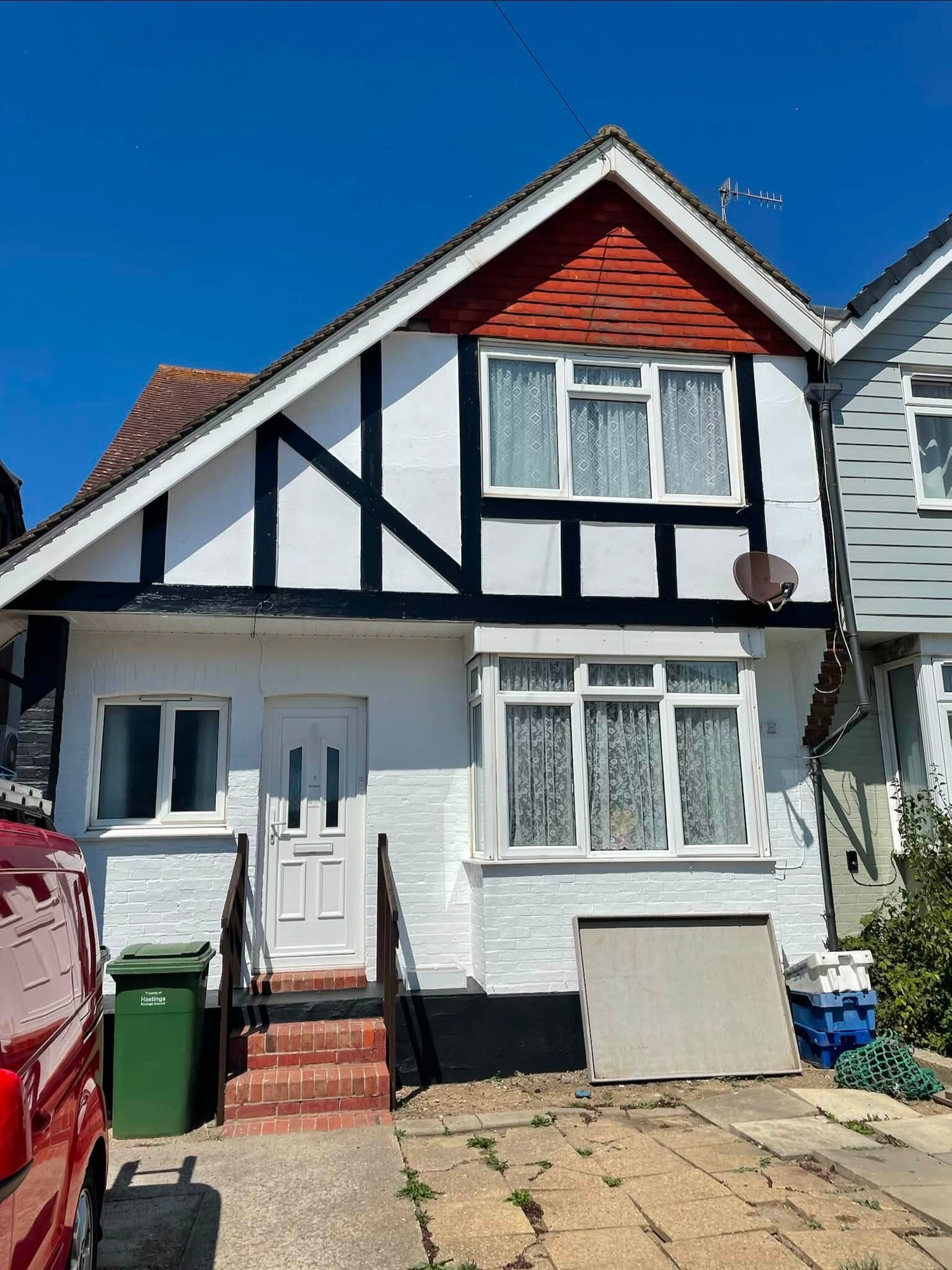Mock Tudor house freshly repainted in white with black timbers